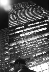 Low section of woman in illuminated office building