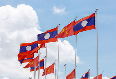 Low angle view of flag flags against sky