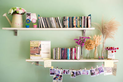 Various objects on shelves on green wall