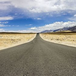 Country road with mountains in background