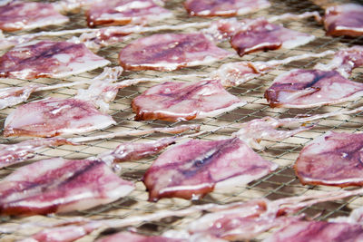 Full frame shot of calamari on metal grate at market for sale