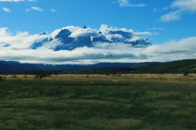 Scenic view of landscape against cloudy sky