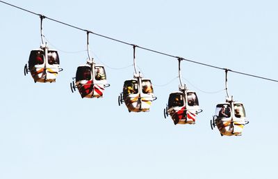 Low angle view of overhead cable car against sky