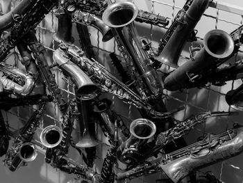 Close-up of saxophones on fence