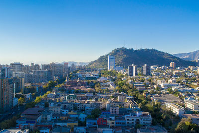 Cityscape against clear blue sky