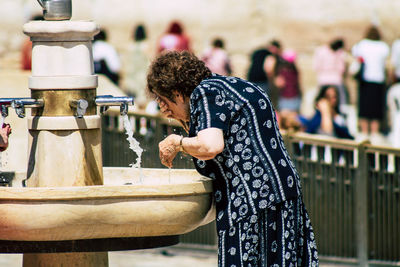 Side view of woman standing outdoors