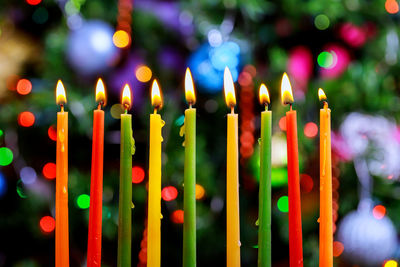 Close-up of illuminated candles on temple