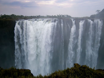 Panoramic view of waterfall against sky