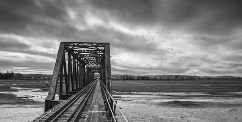 Bridge over land on field against sky