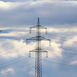 Low angle view of electricity pylon against sky