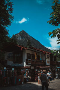 Rear view of woman walking on mountain against sky