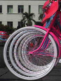 Close-up of bicycle parked on street against building