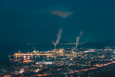 Illuminated cityscape against sky at night