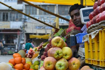 Portrait of vendor selling fruits at market