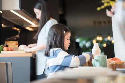 Portrait of woman sitting at restaurant table at cafe