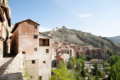 Buildings in town against sky