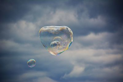 Low angle view of bubbles against sky