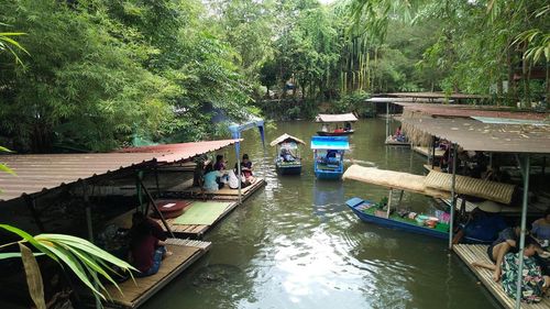 High angle view of boats in canal along trees