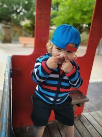 Smiling boy sitting in jungle gym