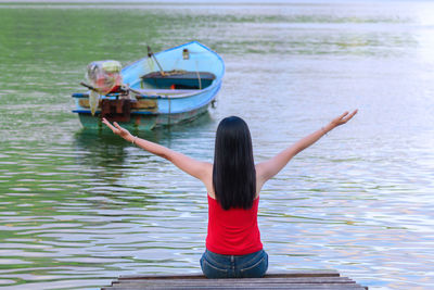 Rear view of woman on boat in sea