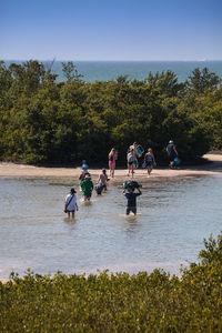 People on beach against sky