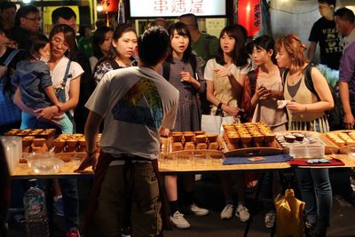 Friends standing at market stall