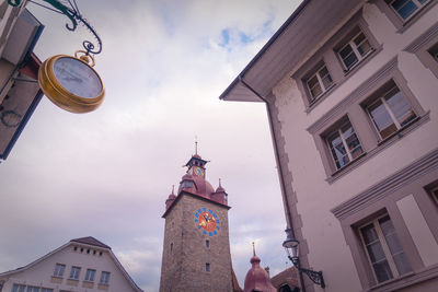 Low angle view of clock tower amidst buildings in city