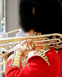 Side view of british royal guard with brass instrument on shoulder