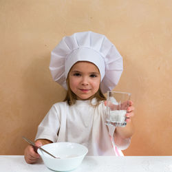 Portrait of young woman drinking water