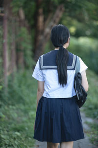 Student wearing school uniform while standing in park