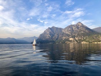 Scenic view of sea by mountains against sky lake of iseo