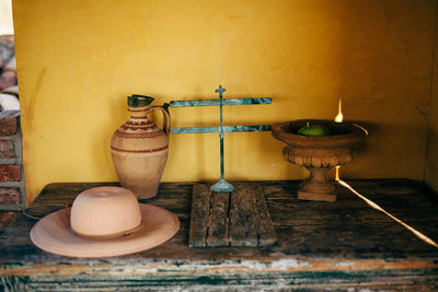 Close-up of fire on table against wall