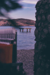 Pier over sea against sky during sunset