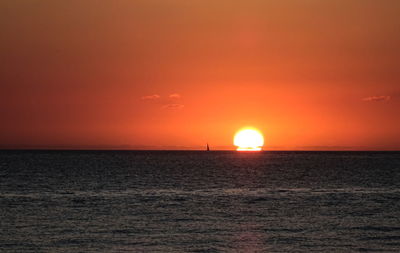 Scenic view of sea against orange sky