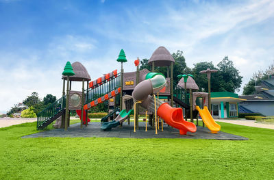 Low angle view of slide at park against sky