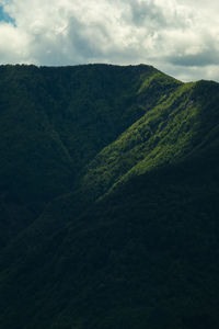 Scenic view of mountains against cloudy sky