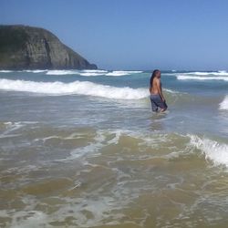 Full length of boy on beach against sky