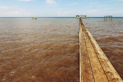 Pier and barge in sea