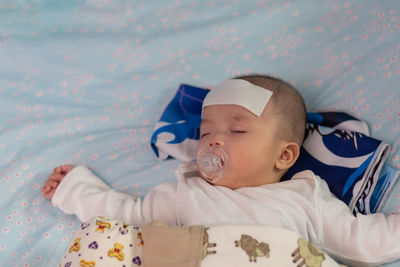 Cute boy sleeping on bed