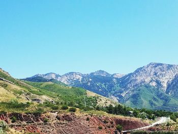 Scenic view of mountains against clear blue sky