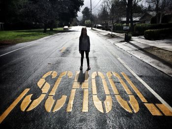 Rear view of man walking on road