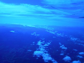 Aerial view of sea against blue sky