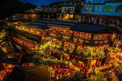 High angle view of illuminated buildings in city at night