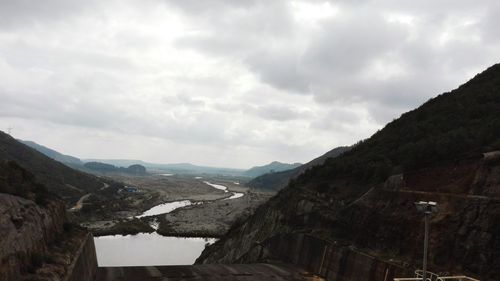 Scenic view of mountains against cloudy sky