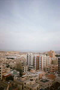 High angle view of buildings in city against sky