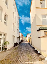 Empty alley amidst buildings in city