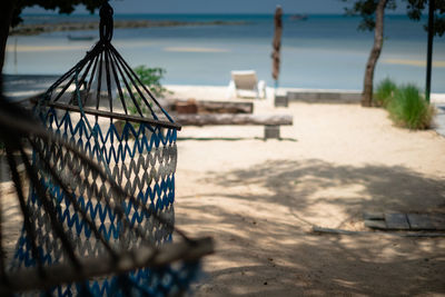 Close-up of deck chairs on beach