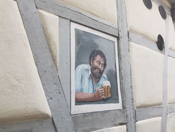 Portrait of man standing by window