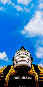 Low angle view of statue against blue sky