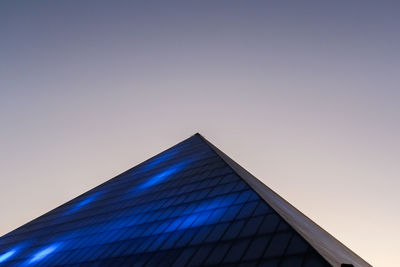 Low angle view of modern building against clear blue sky